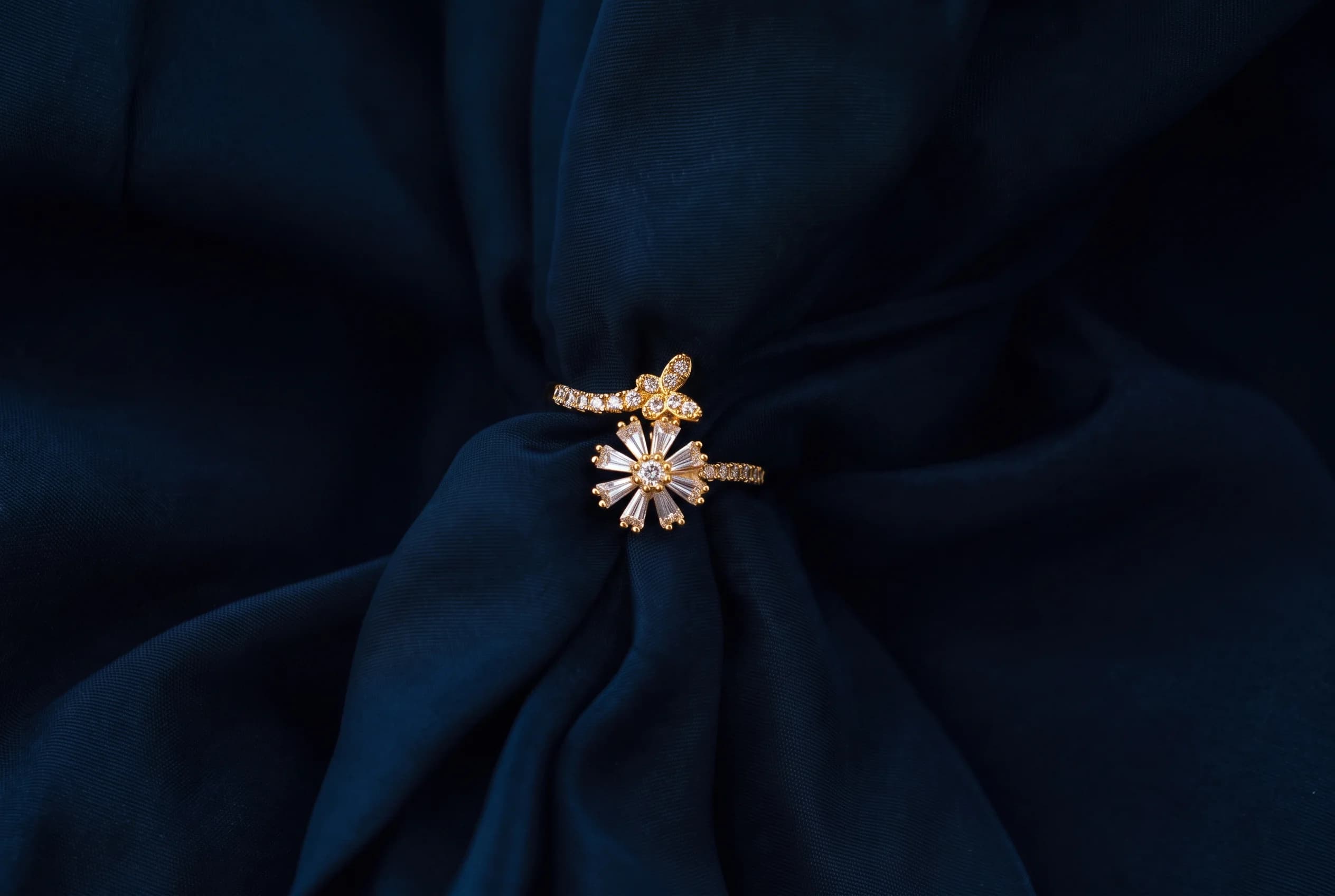 The Jardin gold wrap ring with pave butterfly and baguette floral bloom