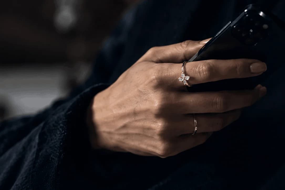 Hands holding smartphone ring detail on mobile