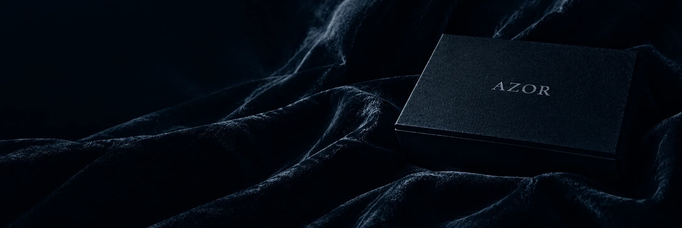 Azor teardrop diamond pendant on dark draped velvet with luxury Azor embossed box