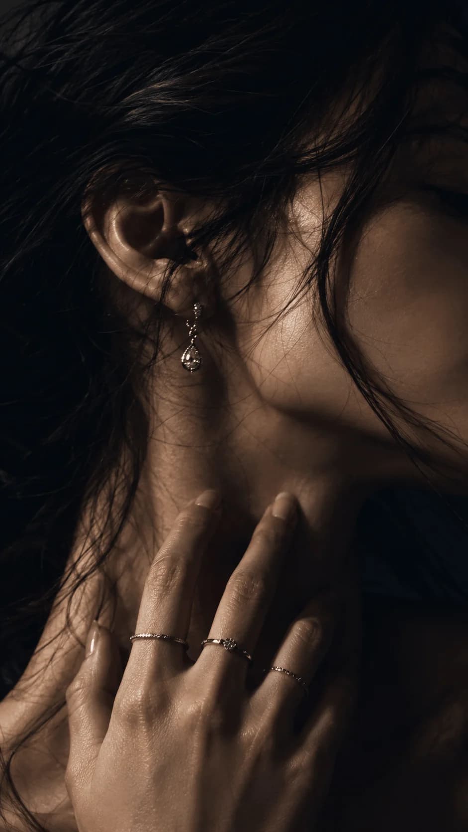 Detail portrait of woman wearing soft minimalist jewelry on mobile